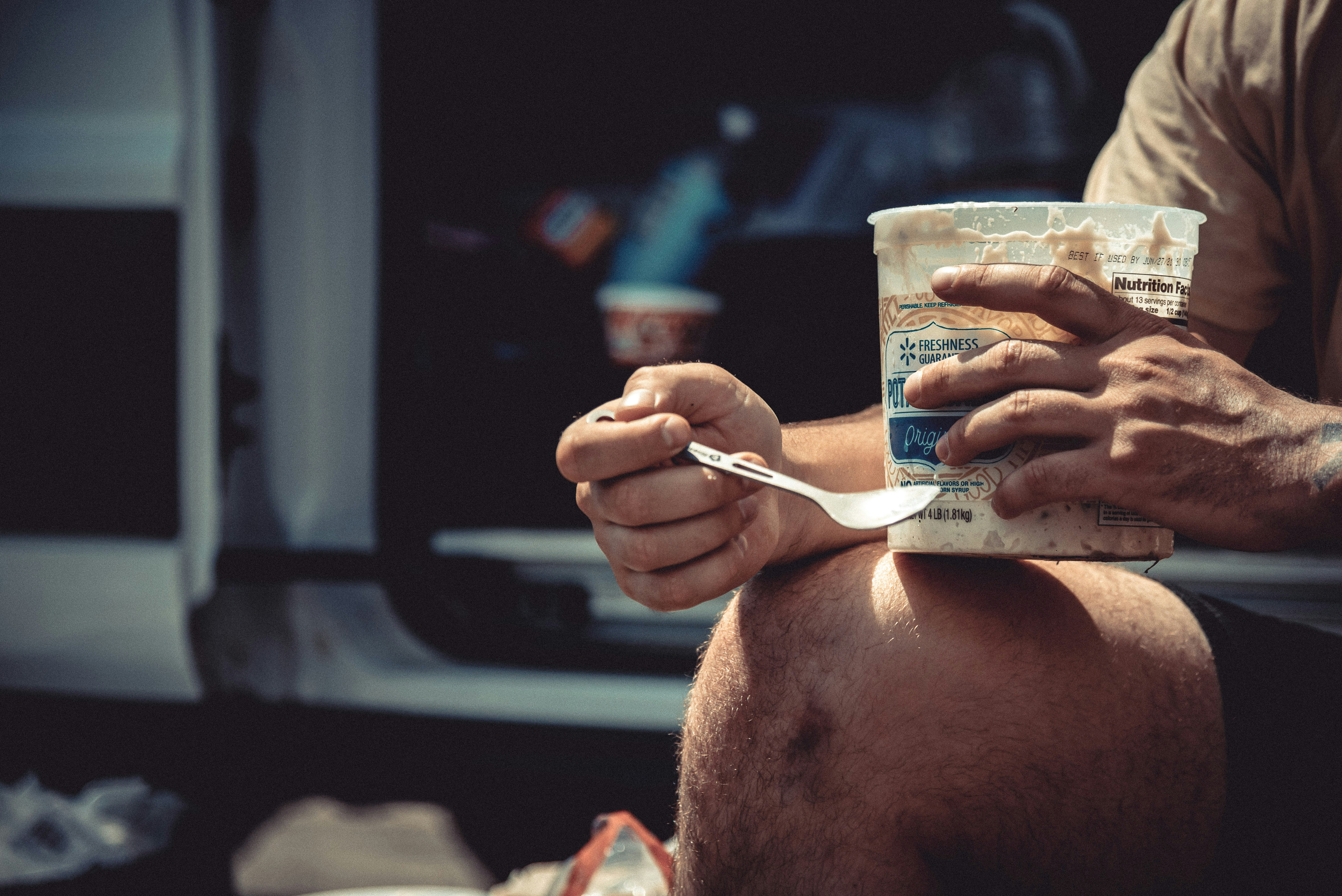 a man eating a can of food