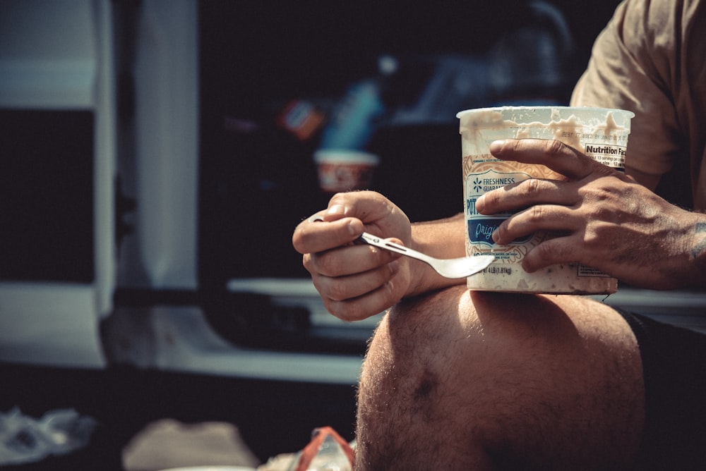 a man eating a can of food