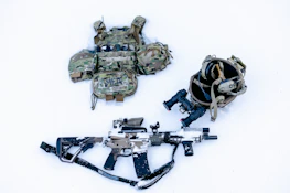 A selection of tactical backpacks and gear laid out ready for deployment.
