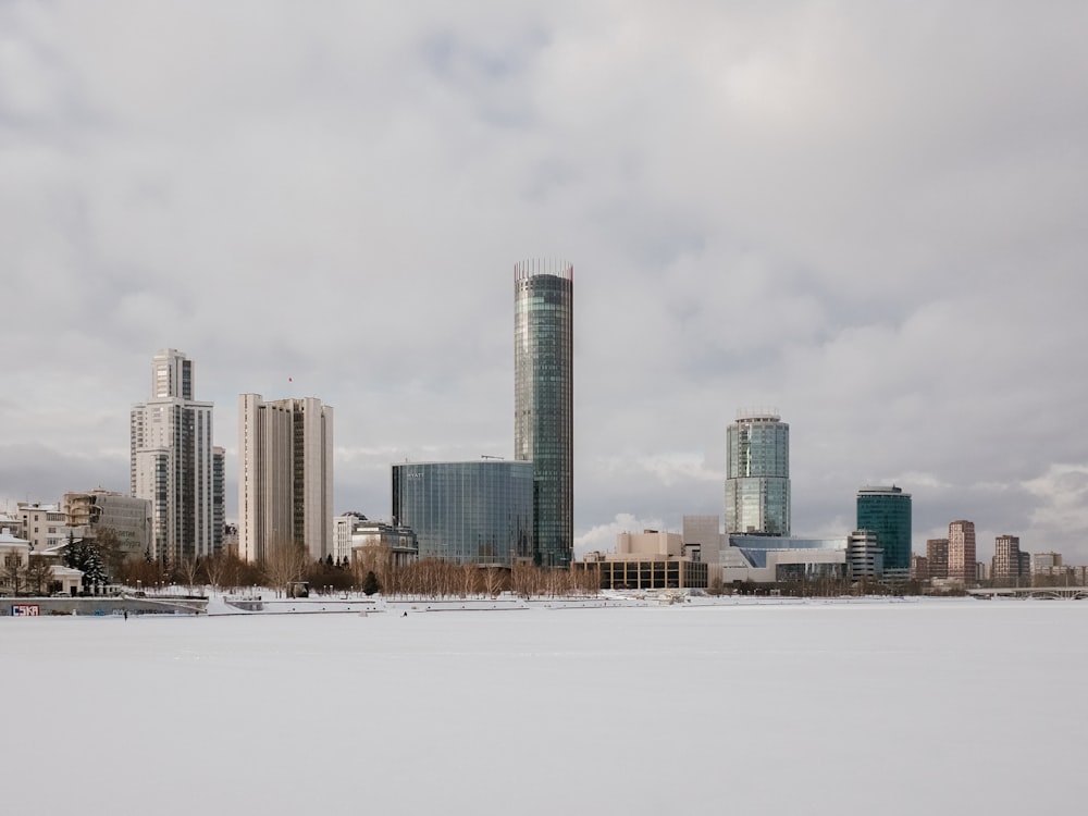 a city skyline with a body of water in the foreground