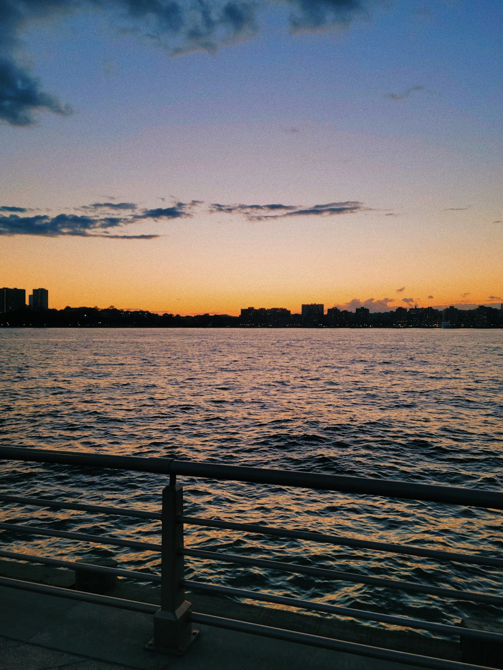 a body of water with a city in the background