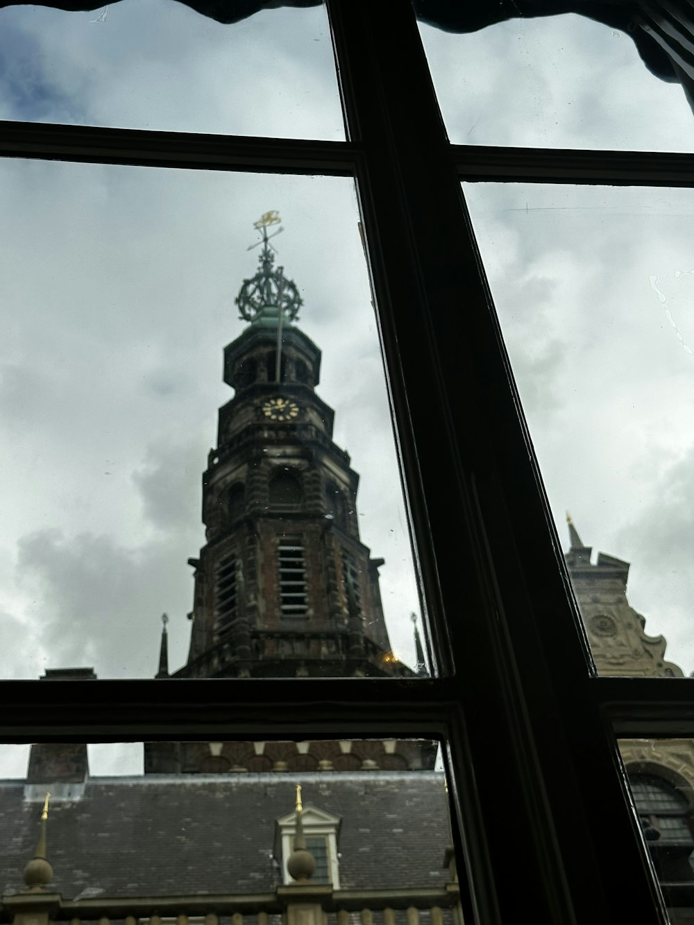 a clock tower with a weather vane