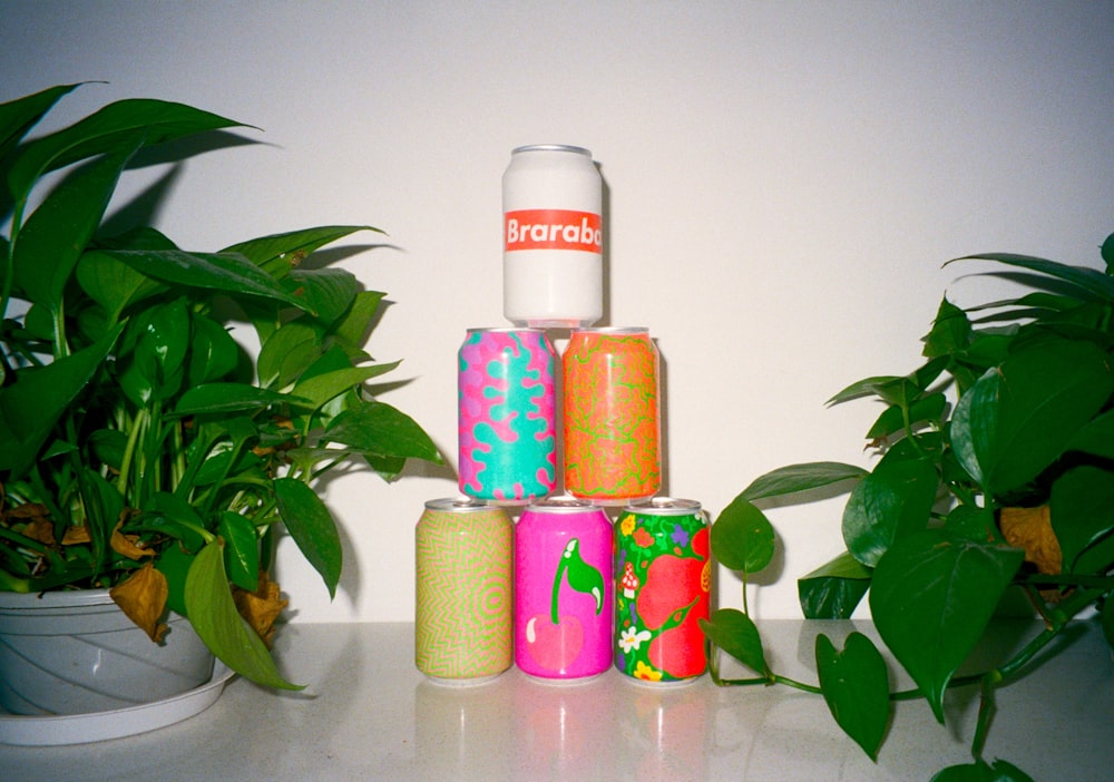 a group of cans next to a plant
