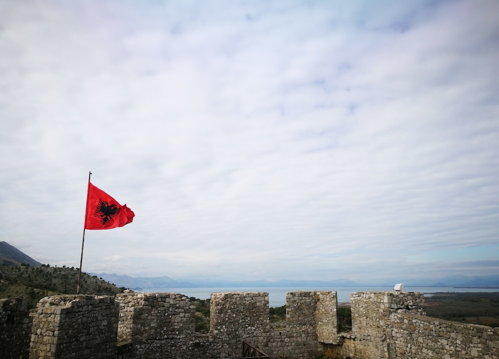 a flag on a stone wall