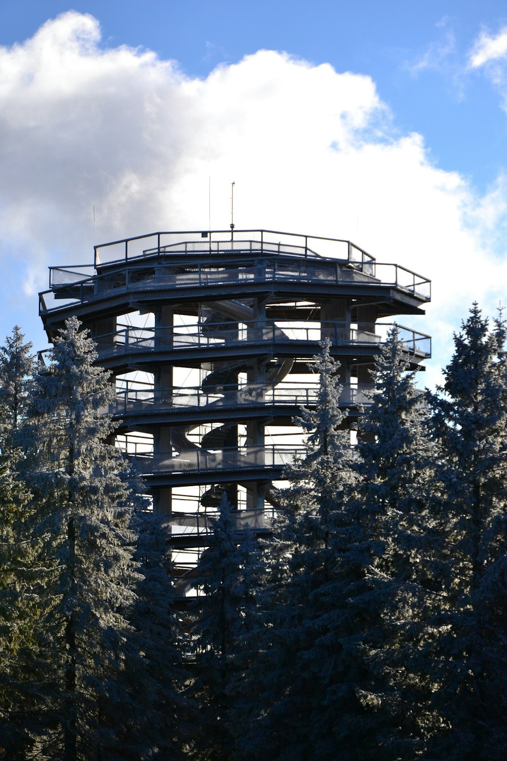 a tall tower with trees around it