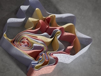 A vibrant close-up of colorful construction material scraps arranged artistically on a light gray background.