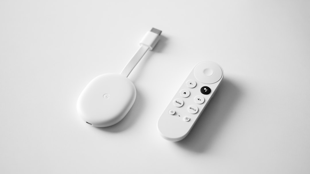 a white video game controller, The Google Chromecast with Google TV.