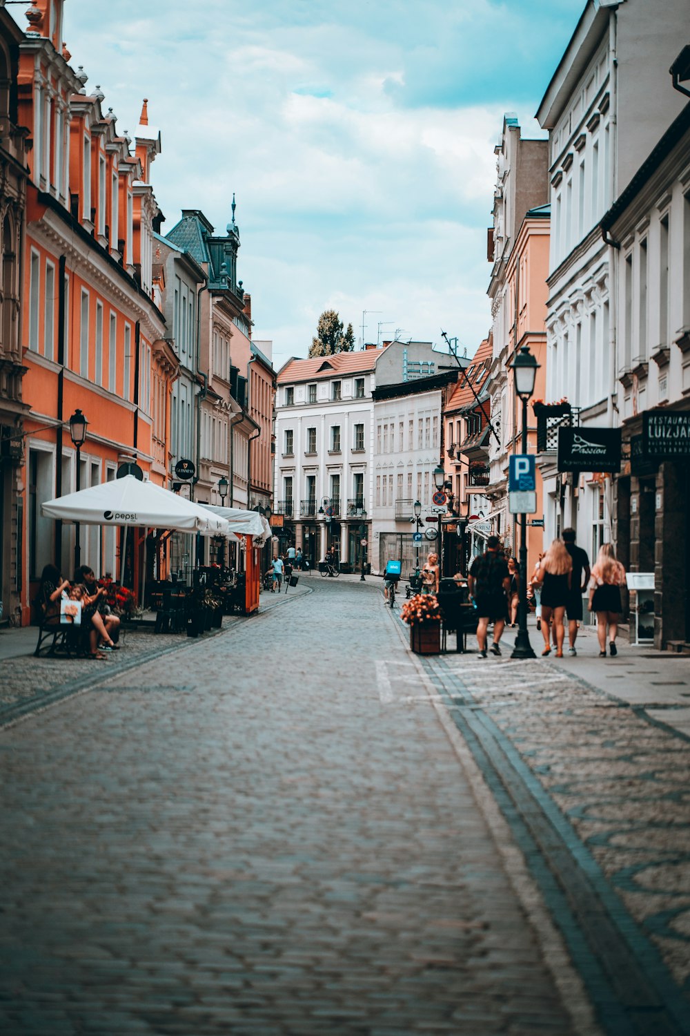 a cobblestone street with buildings on either side of it