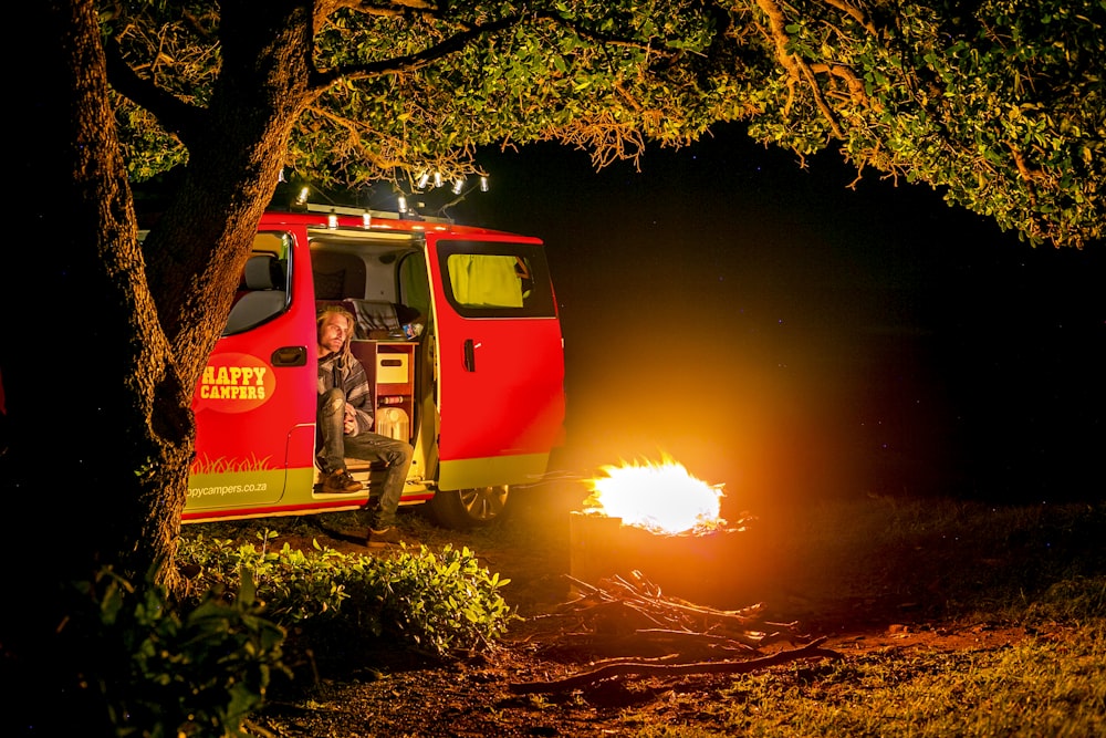 a person standing in a red truck