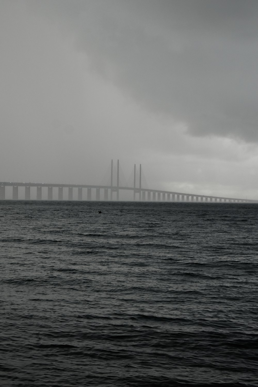 a body of water with a bridge in the distance