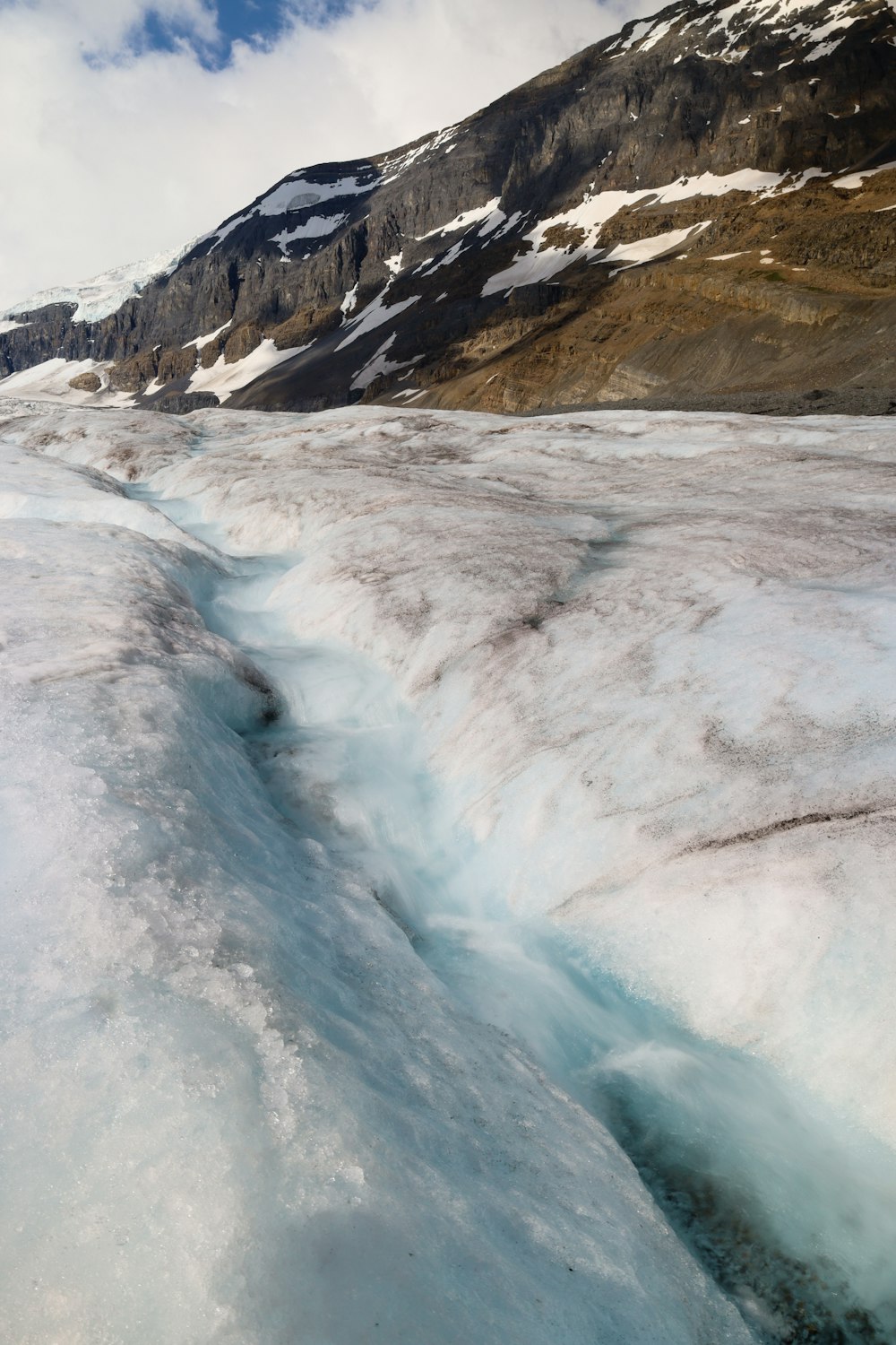 a river running through a snowy mountainous region