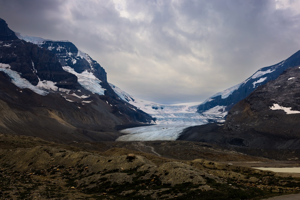 a river running through a valley between mountains