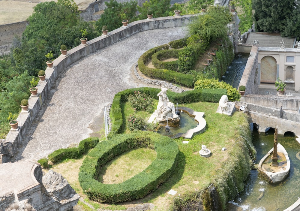 a courtyard with a fountain and statues