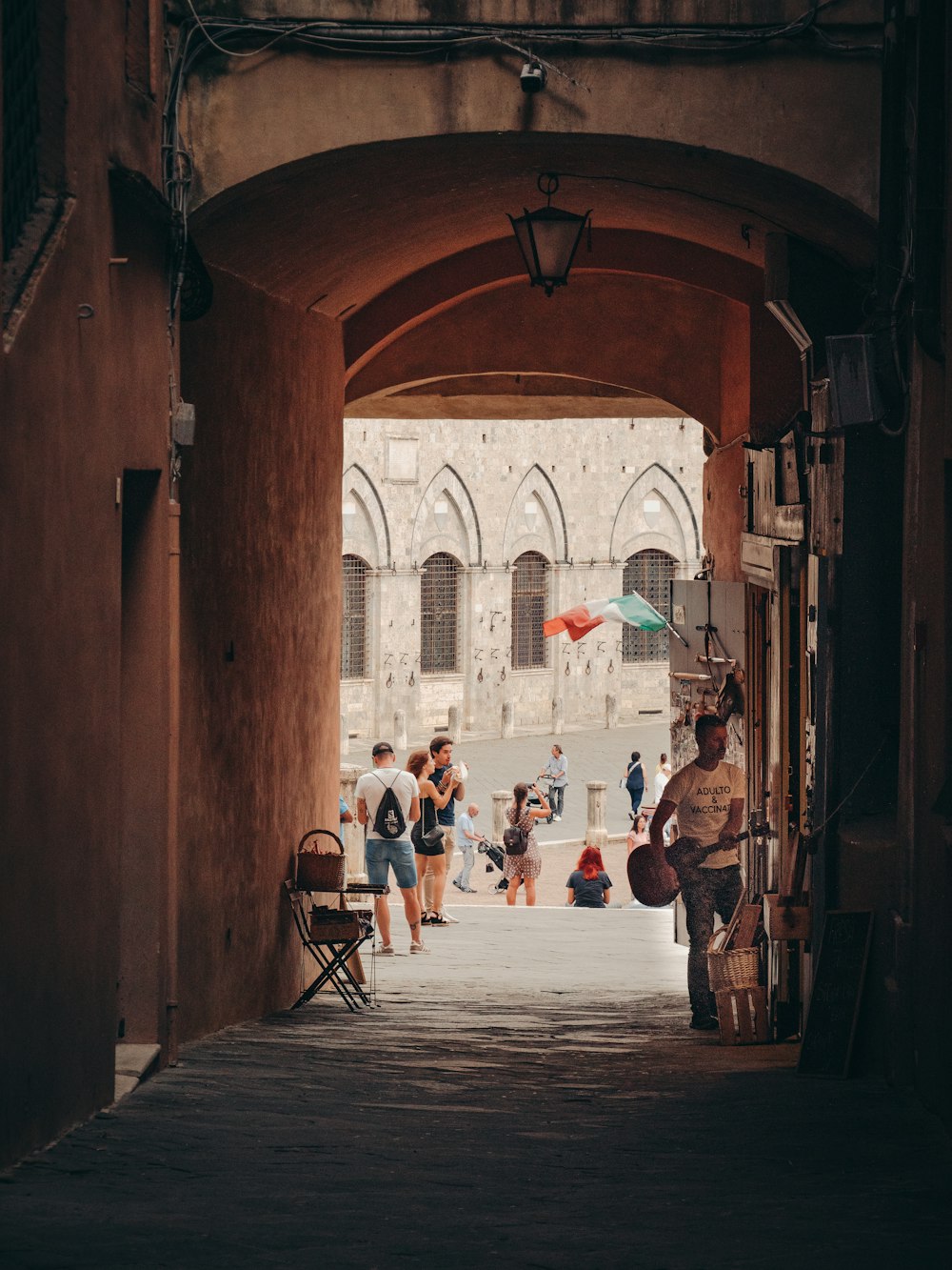 people walking through an old building