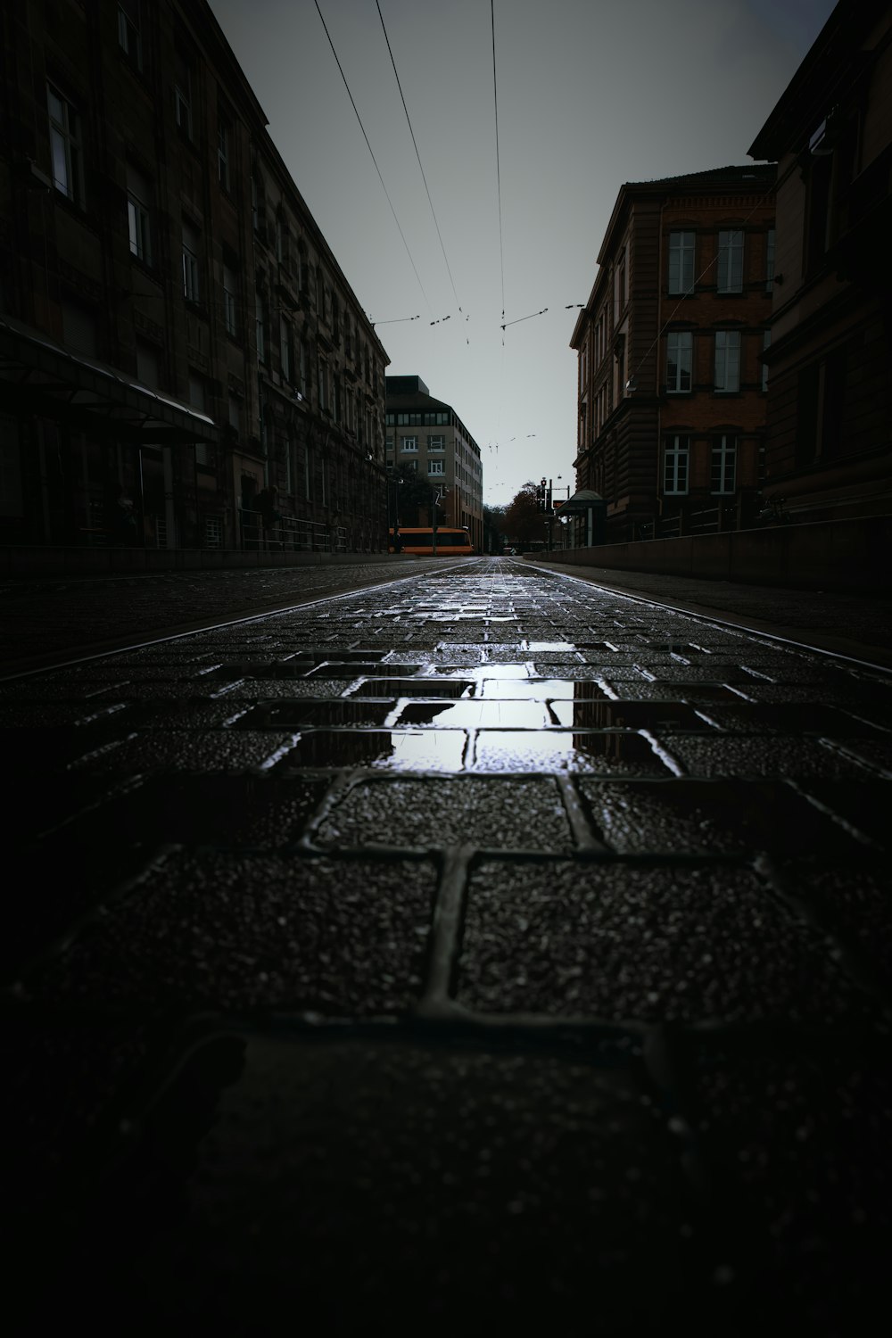 a wet street between buildings