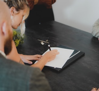 a man writing on a piece of paper