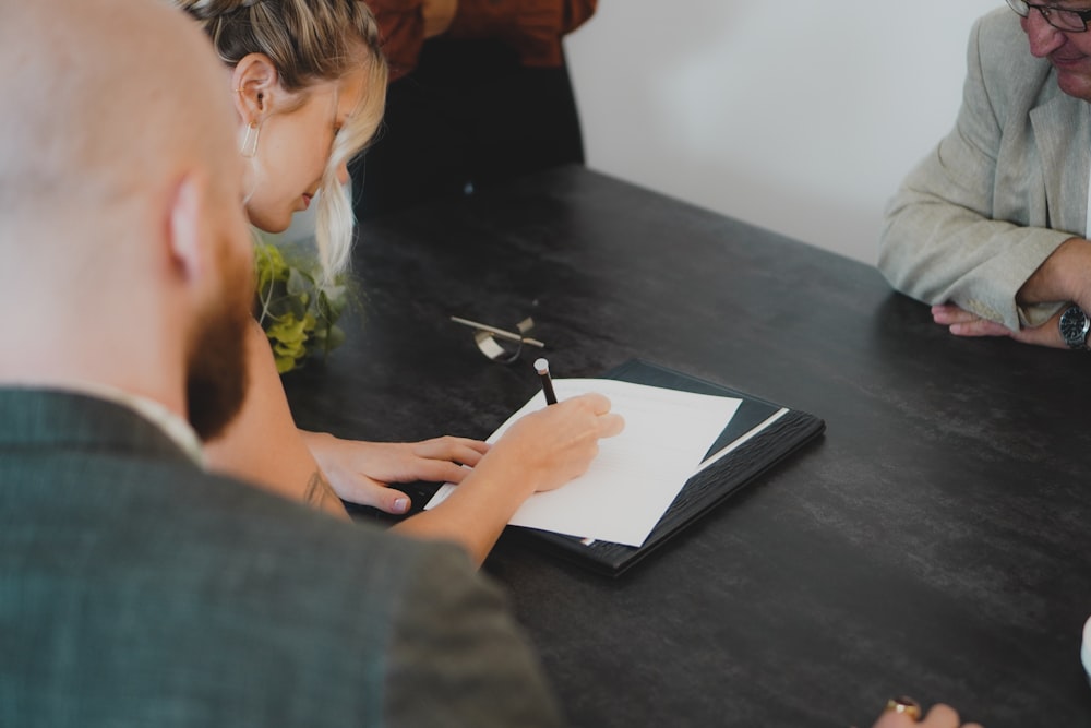 a man writing on a piece of paper