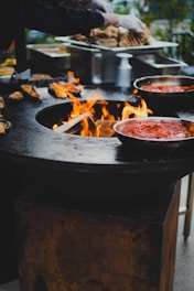 a person cooking food on a grill