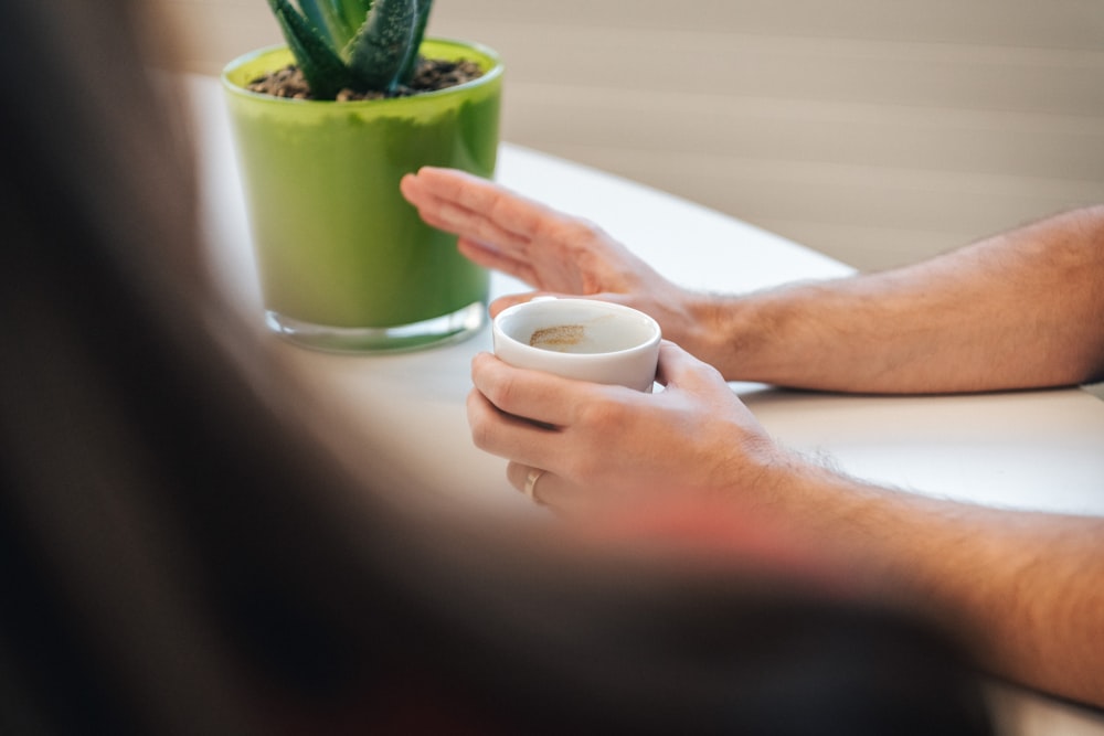 a person holding a cup