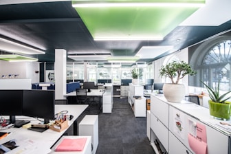 an office with white cabinets and desks