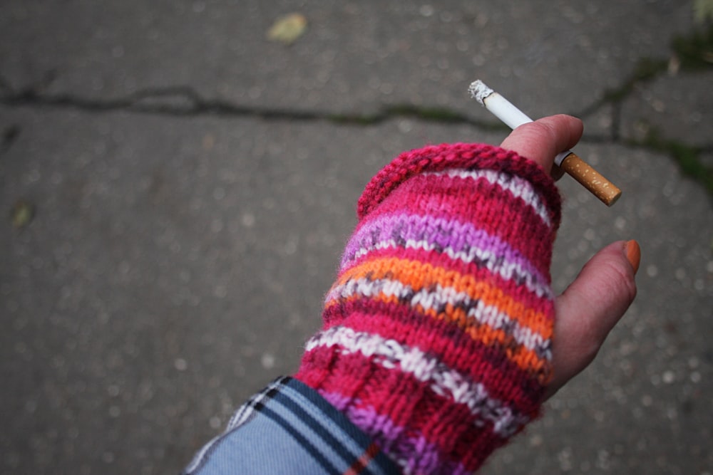 a person holding a cigarette