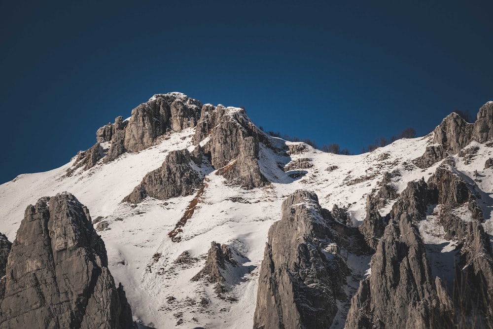 a snowy mountain with a blue sky