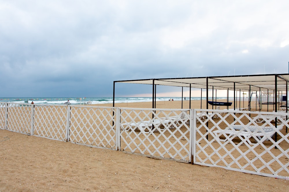 a white railing on a beach