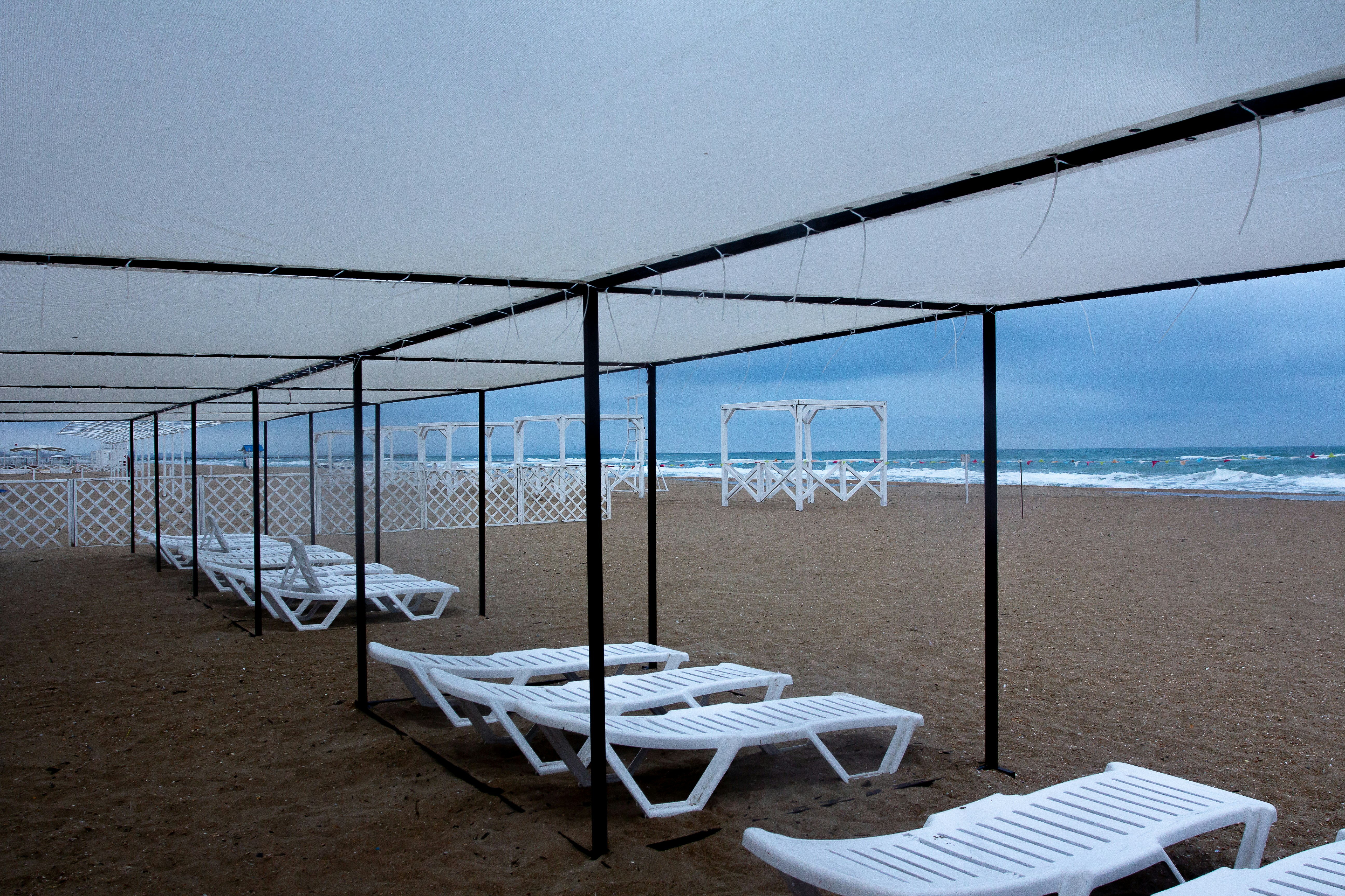 a beach with a gazebo, awful weather