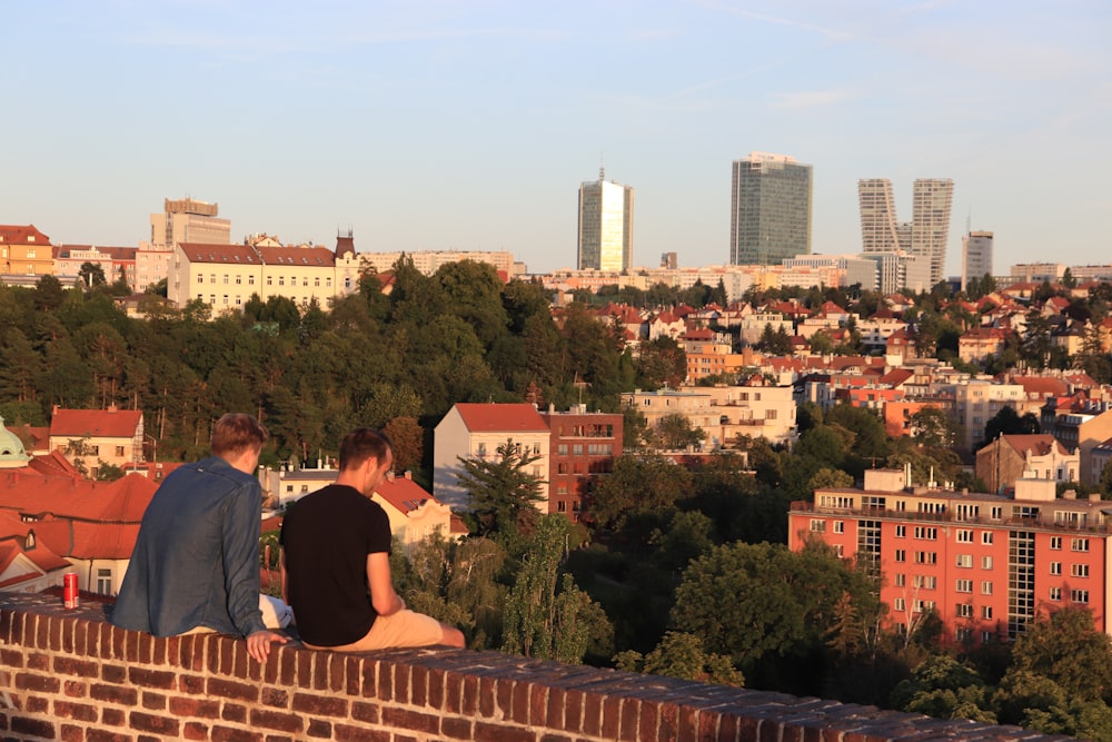 two men sitting on a roof