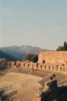 a large ancient building with people standing on the stairs