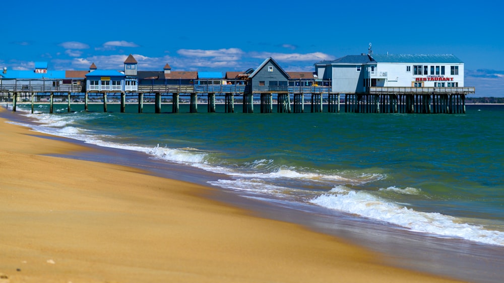 a beach with a pier and buildings