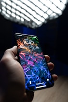 a hand holding a cell phone