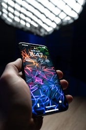 a hand holding a cell phone