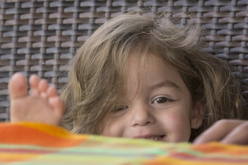 a child lying on a bed