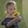 a young girl holding a yellow flower