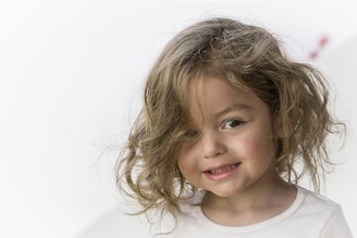 a young girl with curly hair