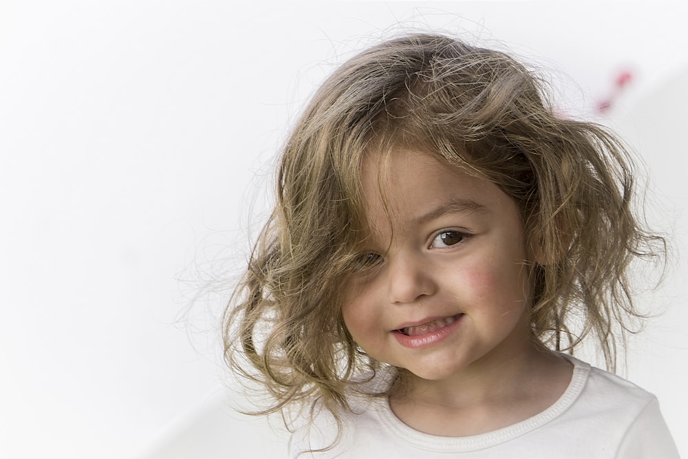 a young girl with curly hair