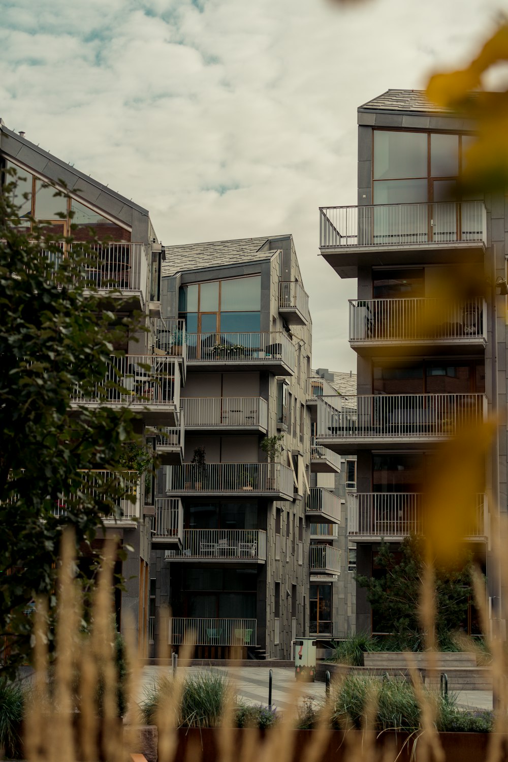 a building with balconies and trees in front of it