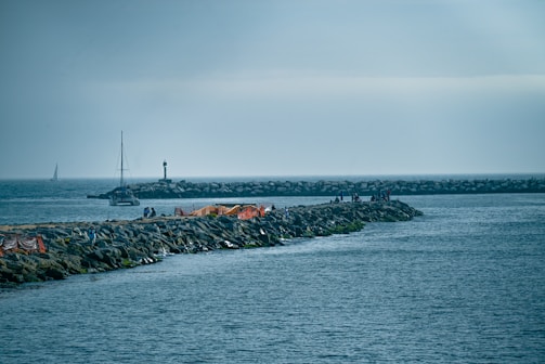 a rocky island with a sailboat