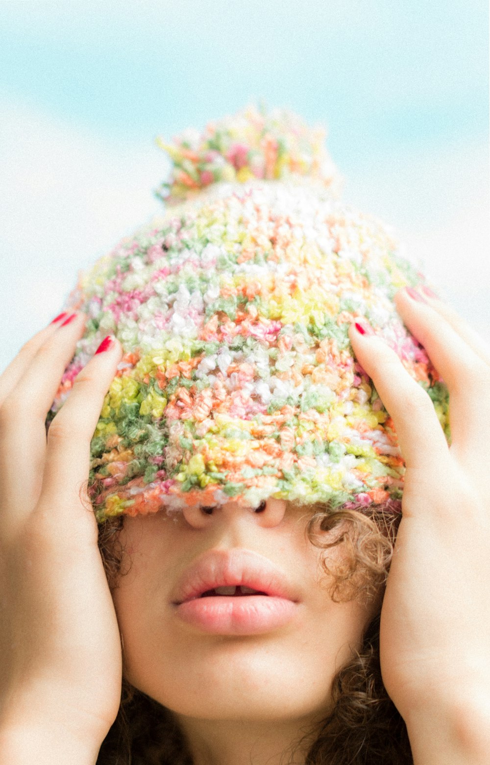 a girl holding a large pile of colorful balls