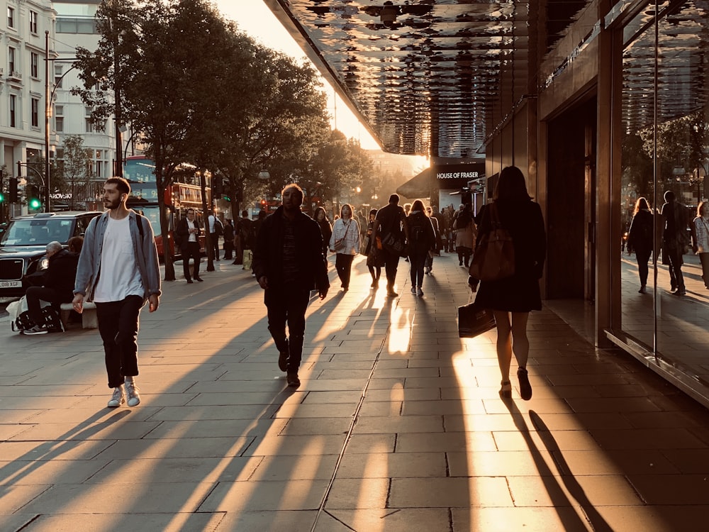 people walking on a sidewalk