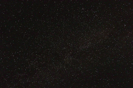 A serene night sky filled with bright stars forming ancient Vedic astrology symbols.