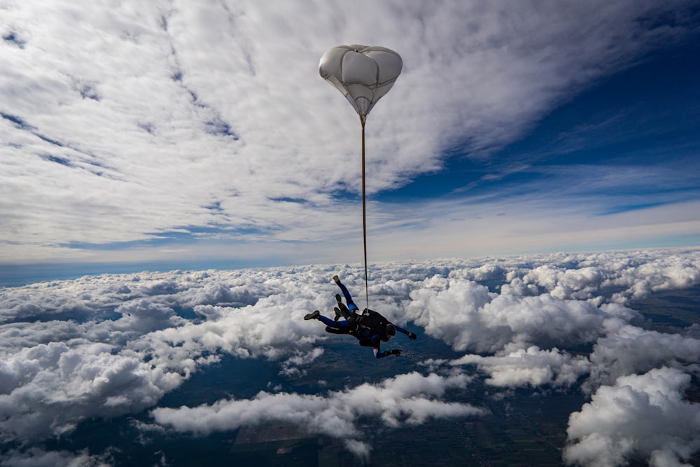 a person in the air with a light post above clouds photo – Free Skydive  Image on Unsplash