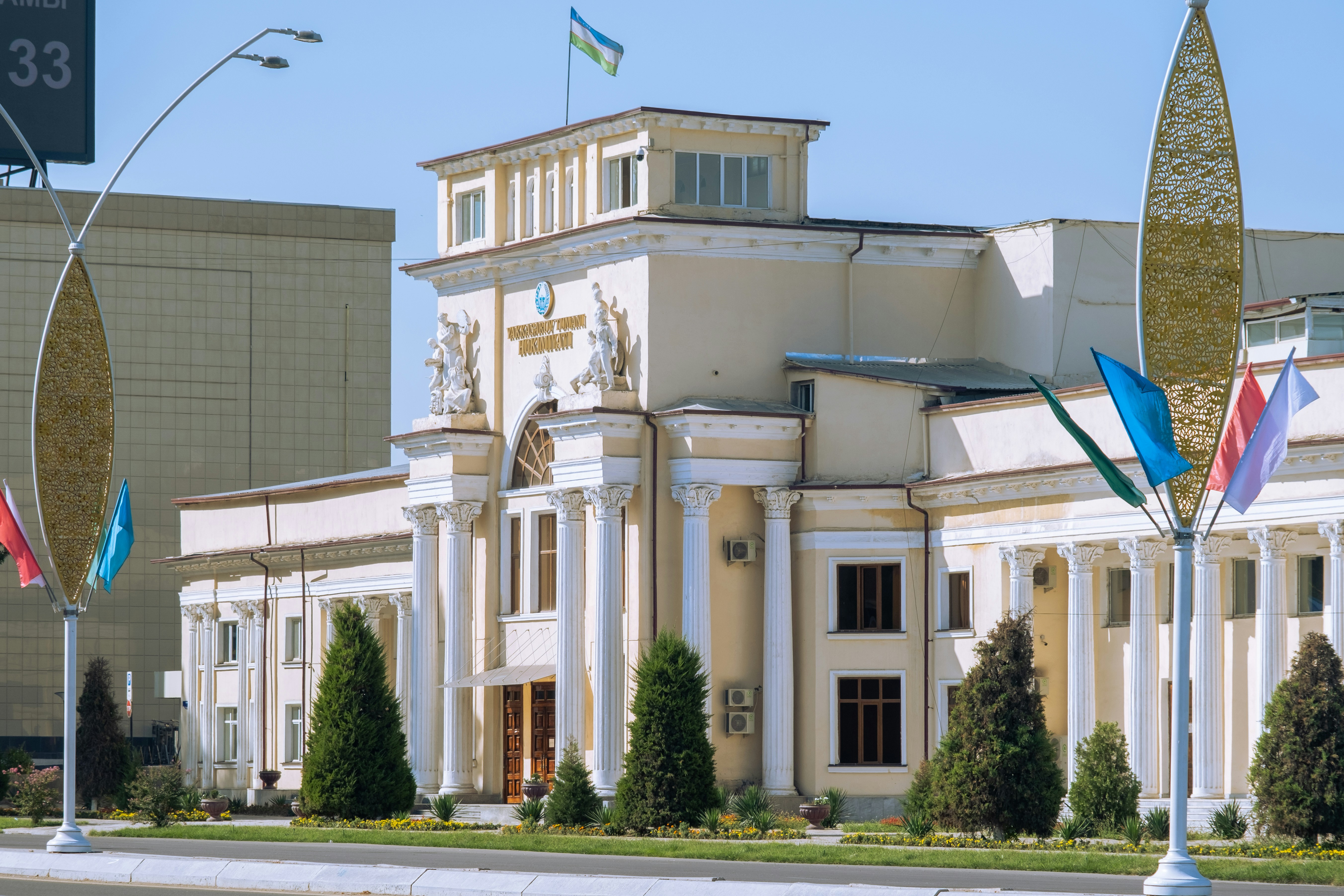 a white building with columns and flags