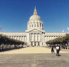a large white building with a dome and a flag on top