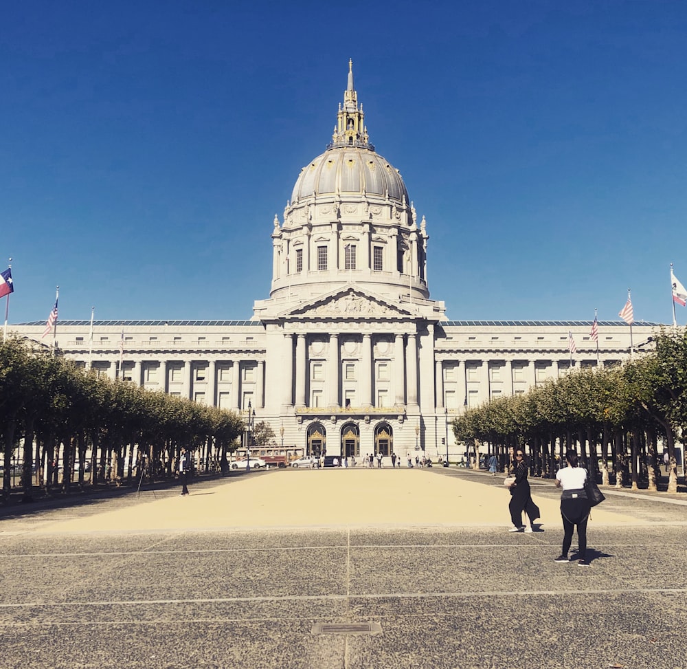 a large white building with a dome and a flag on top