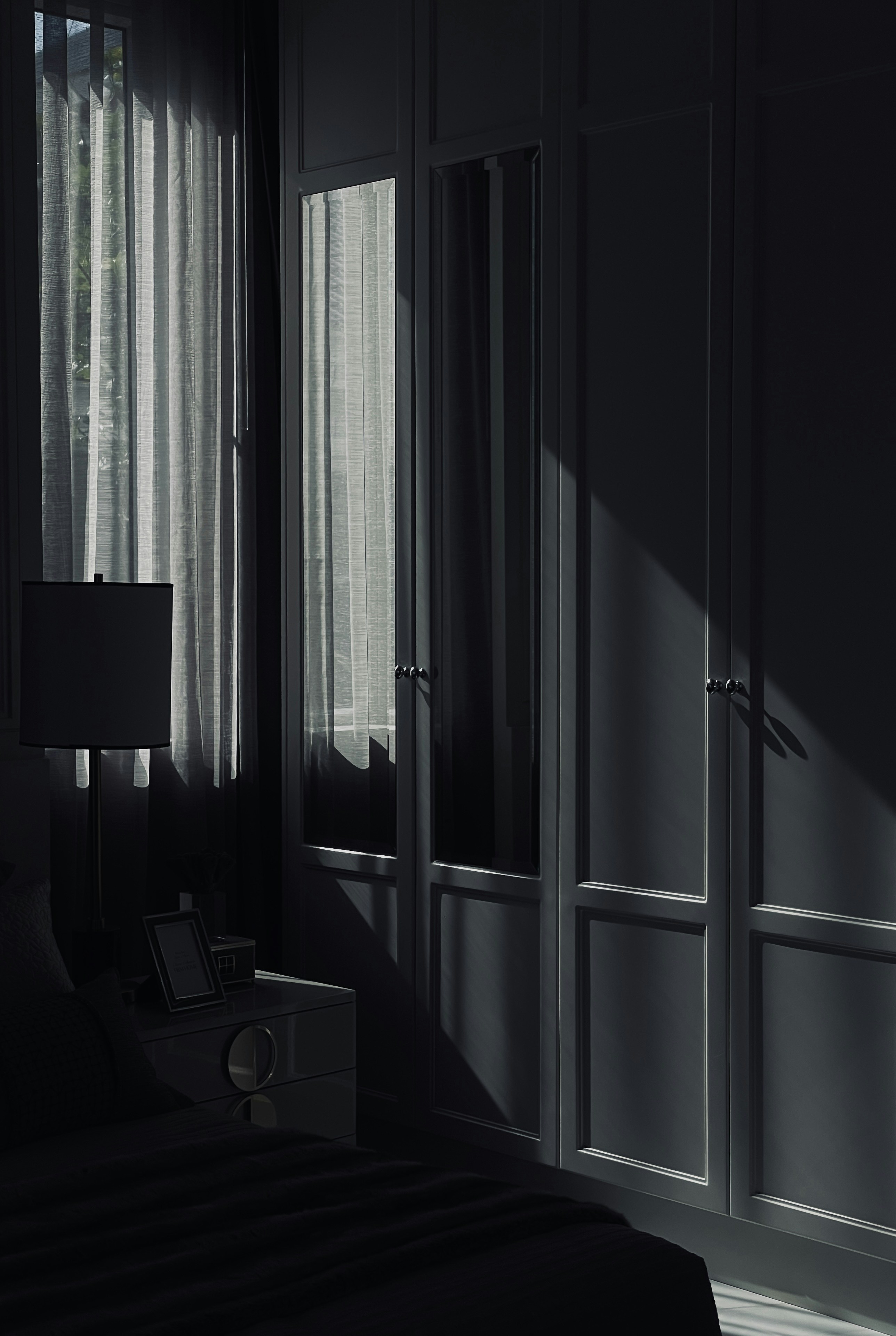 a room with a bed and a lamp