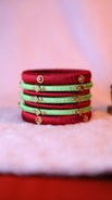 Colorful handcrafted bangles stacked neatly on a wooden surface