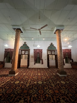 A spacious room with a large, plush carpet featuring subtle geometric shapes.