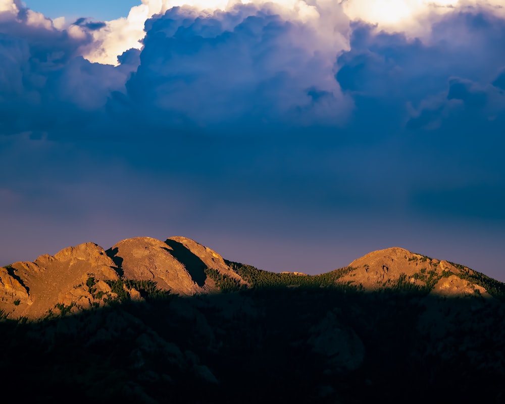 a landscape with hills and clouds